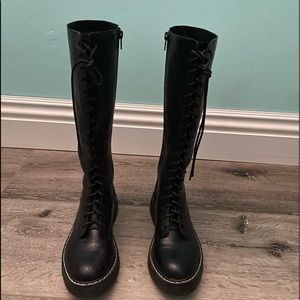 Tall black boots. Doc Martin dupes.